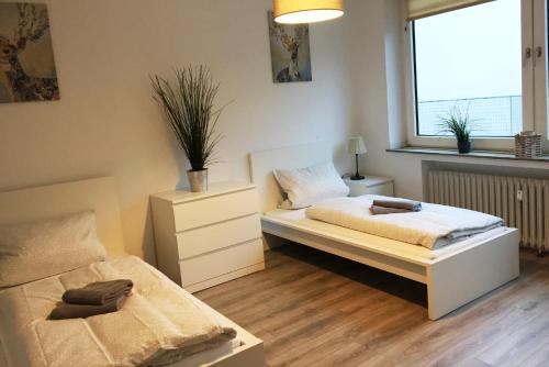 sypialnia z 2 łóżkami i oknem w obiekcie Nice and cozy apartment with Wifi and balcony w mieście Neuss