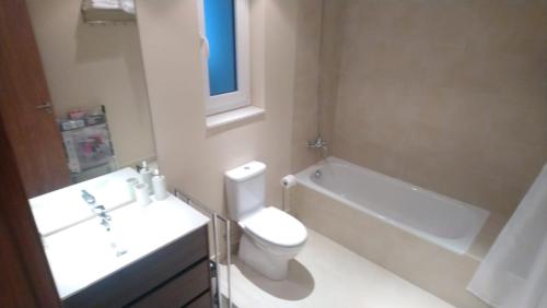 a bathroom with a toilet and a sink and a bath tub at OtaRibasol in Arinsal