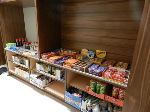 a store shelf filled with lots of food at Radisson Hotel & Conference Centre Calgary Airport in Calgary