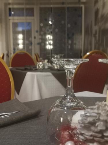 a table with a glass vase on top of a table at Hotel BEST with FREE PARKING in Rīga