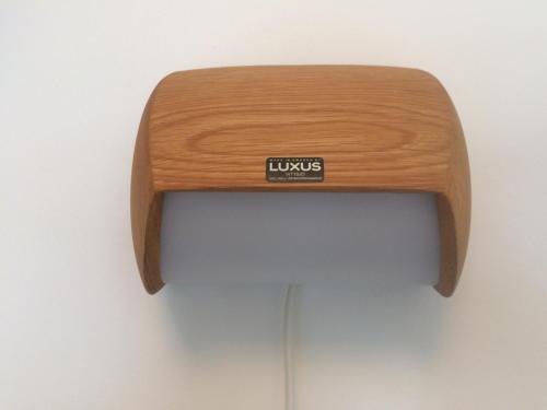 a wooden bench with a sign on the back of it at Hotell Hanöbris på Kivik in Kivik
