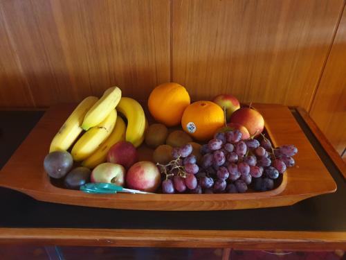 a plate of fruit on a wooden table at Hotell Hanöbris på Kivik in Kivik