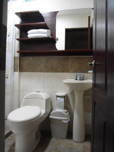 a bathroom with a white toilet and a sink at Hotel La Magdalena in Cartagena de Indias