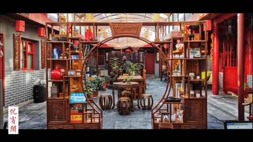 a store with tables and chairs in a building at Beijing Yue Bin Ge Courtyard Hotel in Beijing