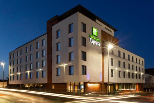 a large building with a clock on the side of it at Holiday Inn Express Cheltenham Town Centre, an IHG Hotel in Cheltenham
