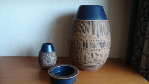 two vases sitting on a table with two bowls at Hotell Hanöbris på Kivik in Kivik