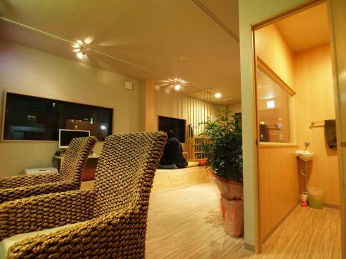 a living room with a leopard print couch and a table at Guesthouse Nara Komachi in Nara