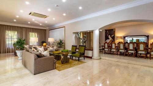 a living room with a couch and a dining room at Christies at 32 on Russell in Nelspruit