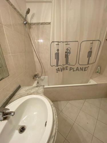 a bathroom with a sink and a shower and a toilet at OCEAN VIEW Quartos in Faro