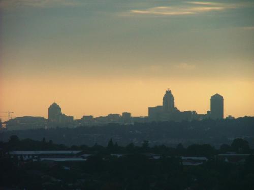a view of a city skyline at sunset at Orangerie Guest House in Johannesburg