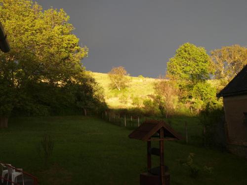 a view of a yard with a hill in the background at Hibiszkusz Haz in Bekölce