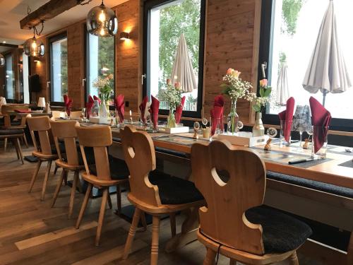 a long table in a restaurant with wooden chairs at Berggasthaus Eggberge - Boutique Mountain Hotel - Access via Cablecar in Altdorf