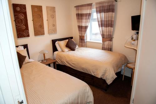 מיטה או מיטות בחדר ב-Redbeck Motel
