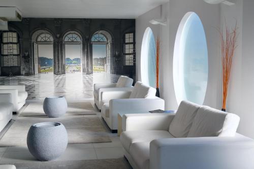 a lobby with white couches and tables and windows at Ahr Hotel Villa Alighieri in Stra