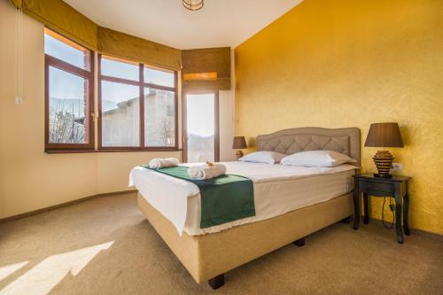 a bedroom with a large bed and a window at Casa Moritz in Braşov