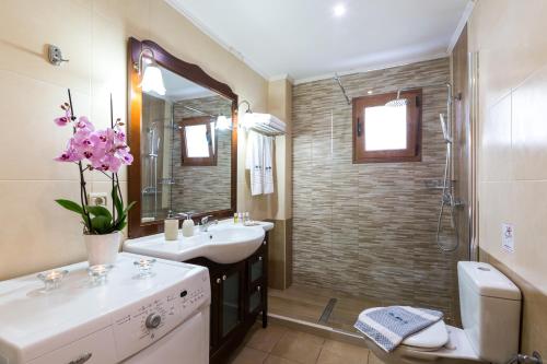 a bathroom with a sink and a shower at Triopetra Luxury Villas Panagia in Triopetra