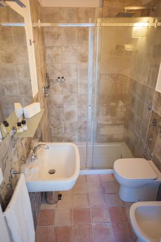 a bathroom with a shower and a sink and a toilet at Masseria Testaferrata in Siracusa