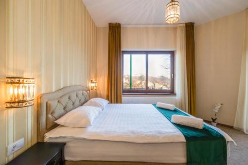 a bedroom with a large bed with a window at Casa Moritz in Braşov
