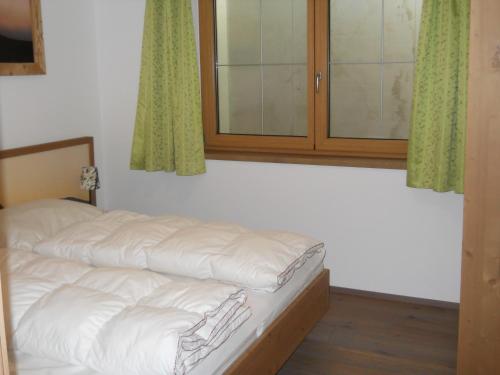 Ein Bett oder Betten in einem Zimmer der Unterkunft Bergappartement Talblick