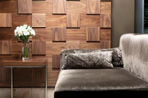 a couch and a table with a vase of flowers at Jalta Boutique Hotel in Prague