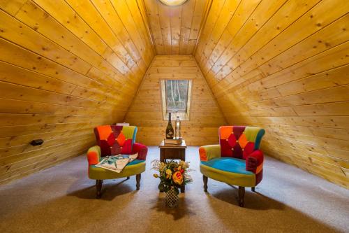 a room with two chairs and a table with a lamp at Casa Moritz in Braşov