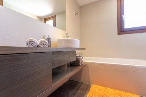 a bathroom with a sink and a tub at Sa Tanca de sa Nina in Mancor del Valle