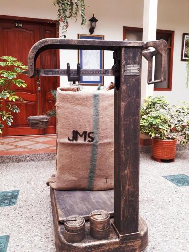 an old sewing machine with three cans on it at Hotel Casa Montero in Quito