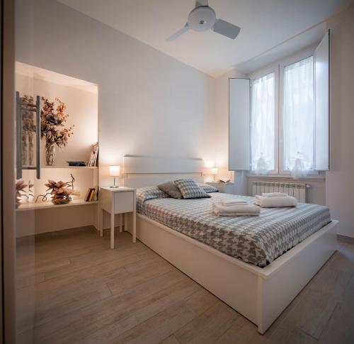 um quarto branco com uma cama e uma janela em Novella White em Florença