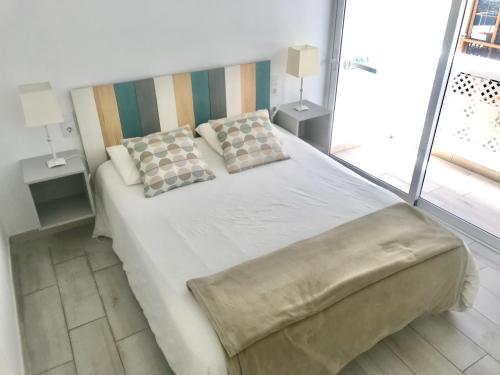 1 dormitorio con 1 cama grande y 2 almohadas en Caleta Soul Apartment, en Puerto de Santiago