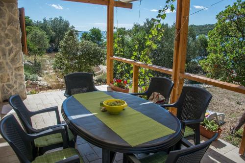 a table and chairs on a patio with a view at House Divna in Kraj