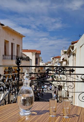a bottle of water sitting on a table on a balcony at Antica Dimora Suites in Rethymno Town