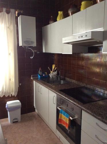 a kitchen with a sink and a stove top oven at Casa Garome 14 PARKING GRATIS in Santa Cruz de la Palma