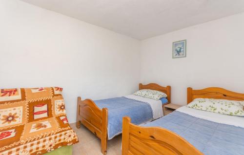 - une chambre avec deux lits et un couvre-lit dans l'établissement House Island Harbour, à Pašman