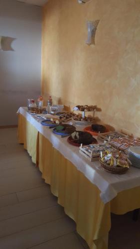 a long row of tables with food on them at Albergo B&B Antica Trattoria Bacco in Circello