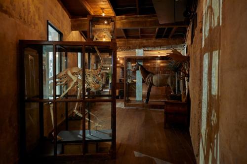 a room with a display case with a horse in it at The Mustang Blu in Bangkok