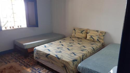 Ένα ή περισσότερα κρεβάτια σε δωμάτιο στο Casa de Praia Ilhéus