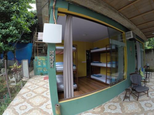 a room with a large window in a house at Hostel MPB Ilha Grande in Abraão