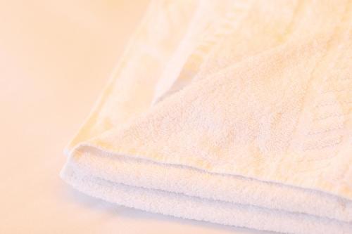 a stack of white towels sitting on a table at George & Pilgrims Hotel in Glastonbury