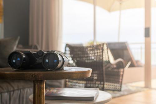 a pair of binoculars sitting on a table in a living room at Beach Villa Wilderness in Wilderness