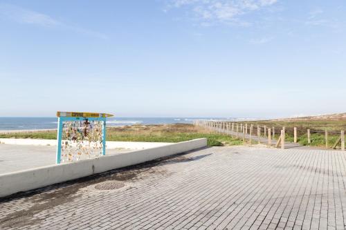 a plaything on the beach with the ocean in the background at Mar Rosa in Aguçadoura