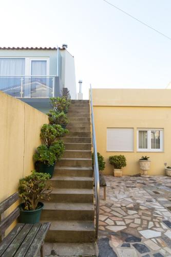 a staircase leading up to a house with potted plants at Mar Rosa in Aguçadoura
