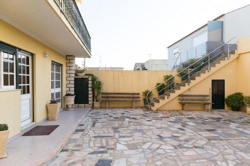 an empty courtyard of a house with stairs at Mar Rosa in Aguçadoura