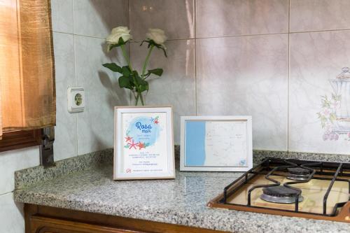 a counter with a sign and a vase with a flower at Mar Rosa in Aguçadoura