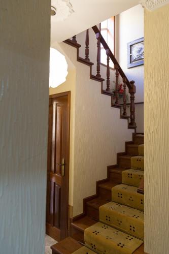 a staircase in a home with a wooden stair case at Mar Rosa in Aguçadoura