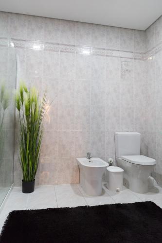 a bathroom with a toilet and a sink at Mar Rosa in Aguçadoura