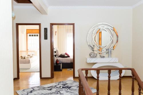 a white room with a mirror and a bed at Mar Rosa in Aguçadoura
