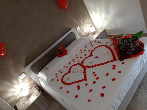 a bed with a cake with hearts on it at B&B iMori in Caltagirone