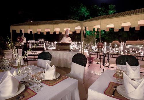a table set up for a wedding with a chef in the background at Ambassador, New Delhi - IHCL SeleQtions in New Delhi