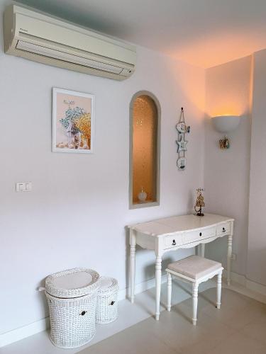 a white dressing table and stool in a room at Chelona huahin beachfront condominium in Khao Tao