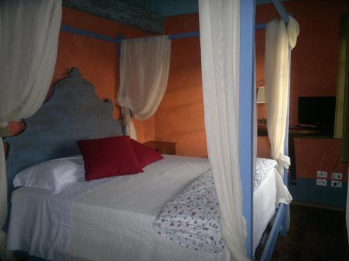 a bedroom with a bed with a red pillow at I Veroni - Agriturismo and Wine Cellar in Pontassieve